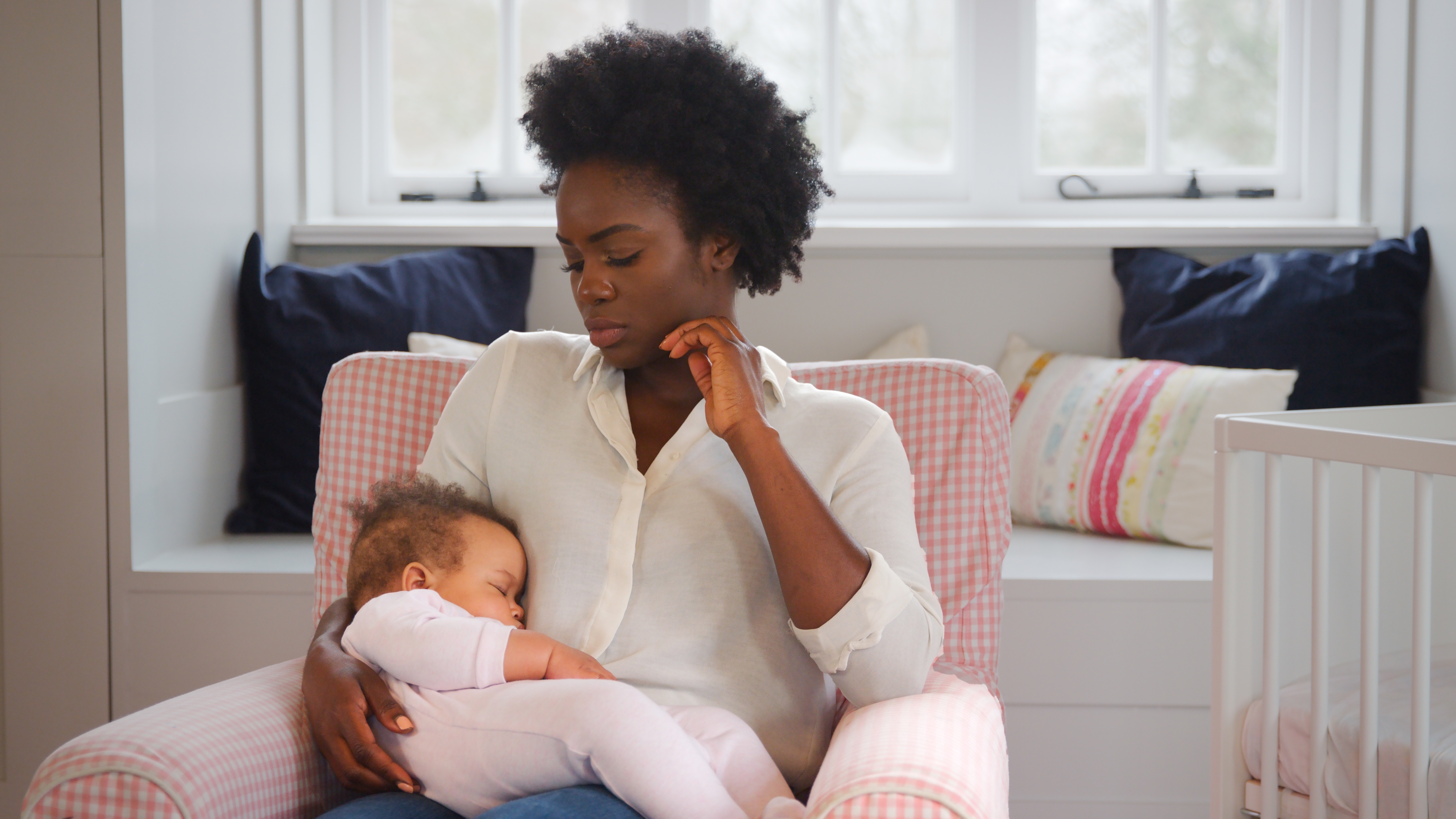 New,Mother,Suffering,With,Post,Natal,Depression,Holding,Sleeping,Baby